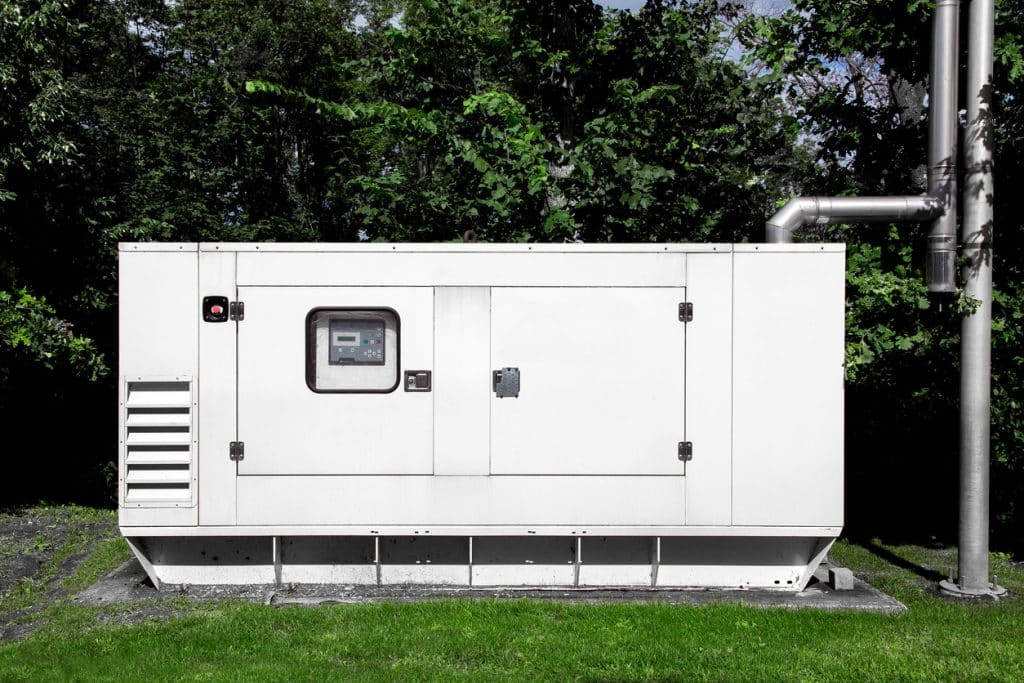 emergency generator mounted on a green lawn